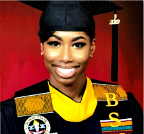 Young woman in a collegiate graduate headshot